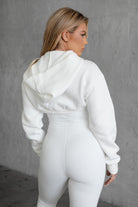 White fleece bolero-style cardigan featuring a cropped fit and zipper front by Tic Toc.