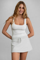 Heather white fleece mini skirt with hidden shorts and smooth fleece material by Tic Toc.