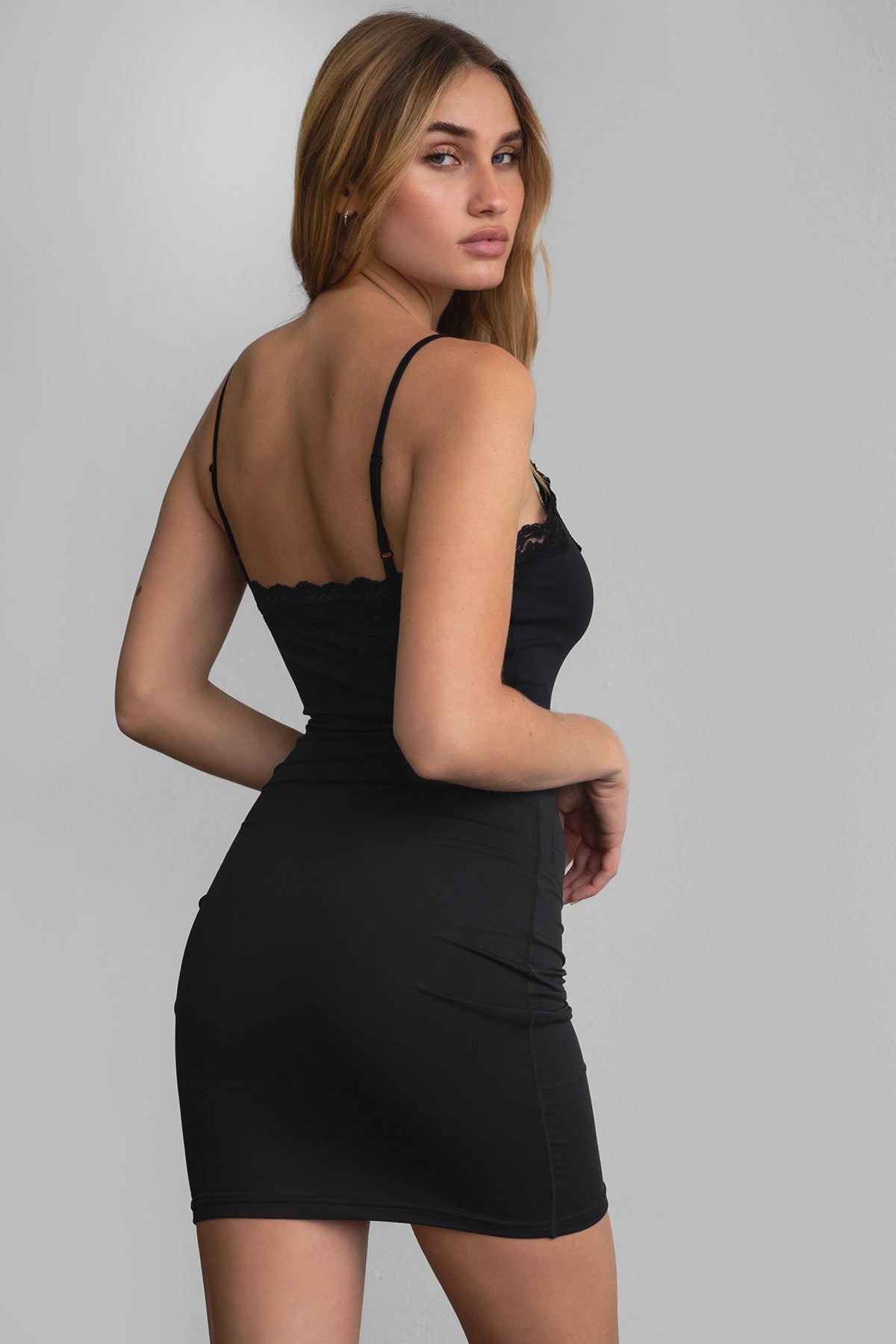  Black mini dress with cami straps and lace details by Tic Toc, perfect for nights out.