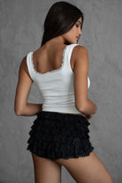 White sleeveless ribbed tank top featuring a low scoop neckline and cropped fit from Tic Toc.