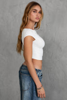 White off-the-shoulder top with stylish ruching and silky fabric by Tic Toc, perfect for casual wear.