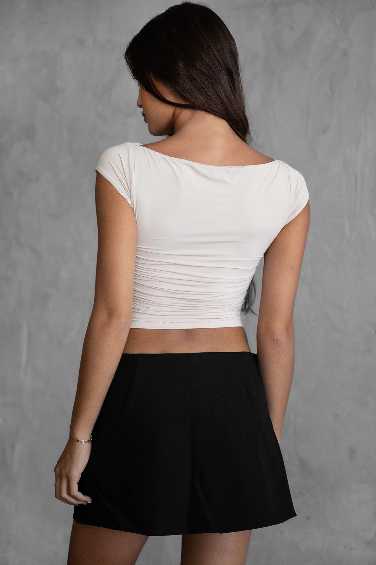 Oatmeal short sleeve top featuring draping along the bodice and sleek spandex fabric from Tic Toc