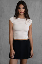 Oatmeal short sleeve top featuring draping along the bodice and sleek spandex fabric from Tic Toc