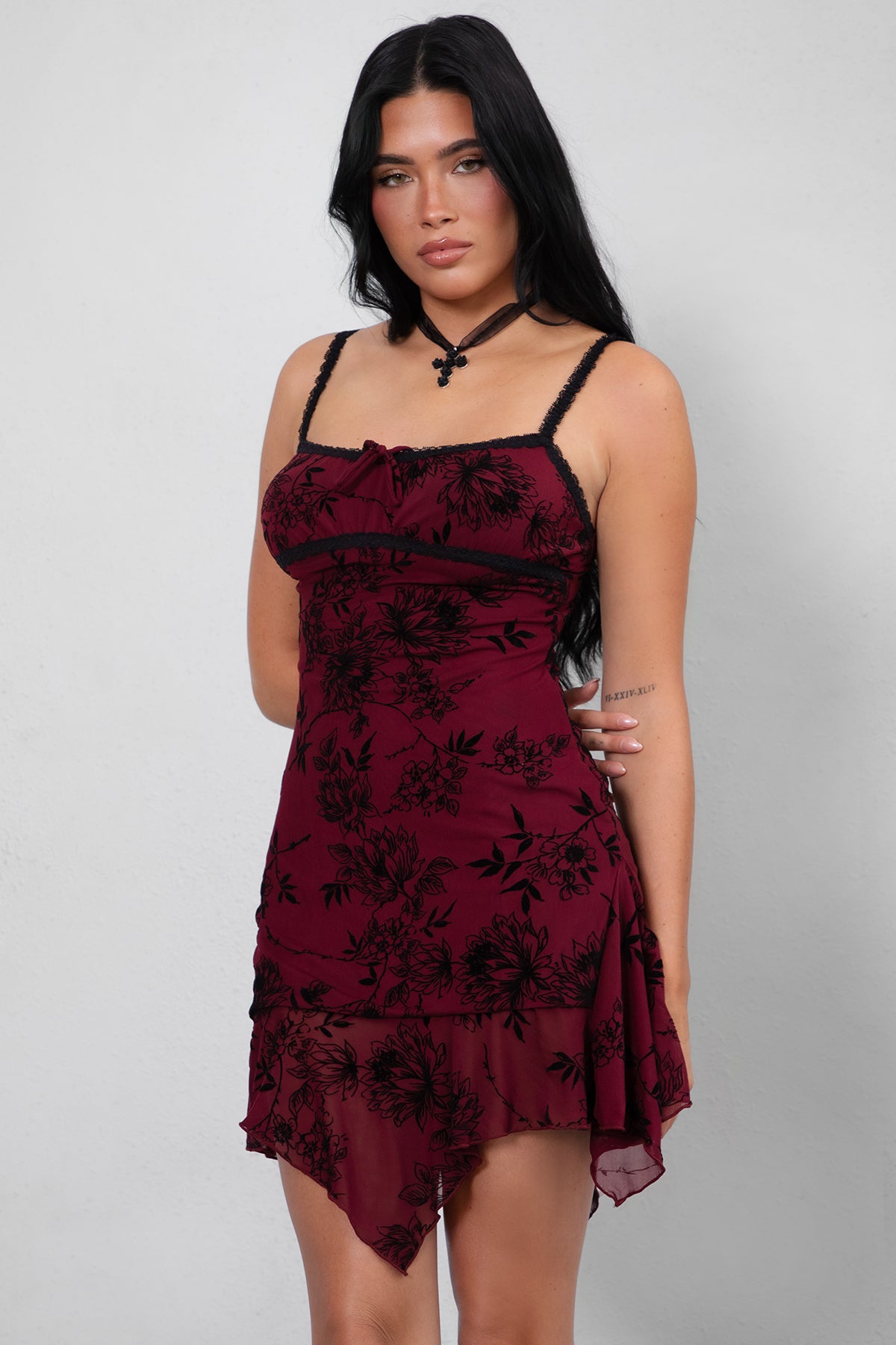  Burgundy mini dress featuring a scoop neckline, tie front detail, and ruffled hem from Tic Toc.