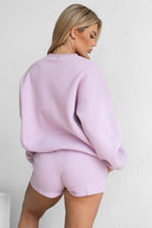 Light lavender fleece mini shorts featuring deep side pockets and an elastic waist by Tic Toc.