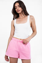 Pink fleece shorts featuring deep pockets and a high-rise elastic waist for comfortable wear by Tic Toc.