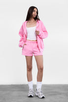 Pink fleece shorts featuring deep pockets and a high-rise elastic waist for comfortable wear by Tic Toc.