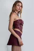 red strapless western corset top by Tic Toc, featuring rope lace-up back and boned panels.