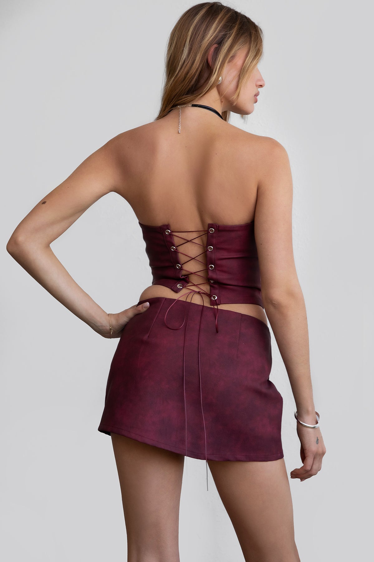 red strapless western corset top by Tic Toc, featuring rope lace-up back and boned panels.