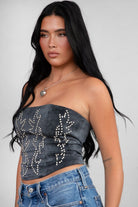 TIC TOC TA29069 BECKEE PU Vegan Leather Corset Top in distressed leather. Features a straight strapless neckline, rhinestone western detail, and lace-up back in color black. 