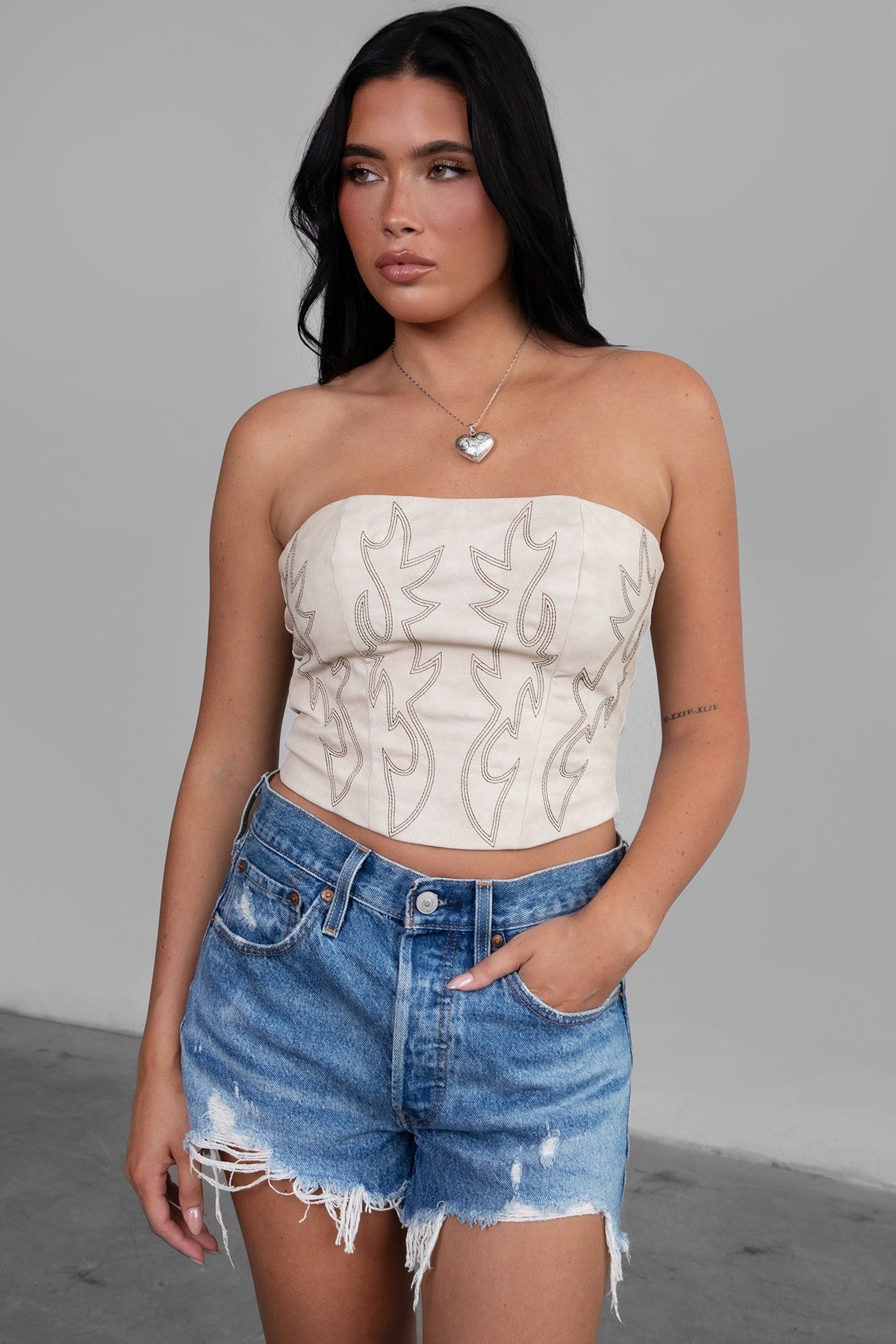 TIC TOC TA29069 BECKEE  PU Vegan Leather Corset Top. Featuring embroidered western details, and an exposed lace up back. Perfect for bold, edgy, and Western-inspired looks.