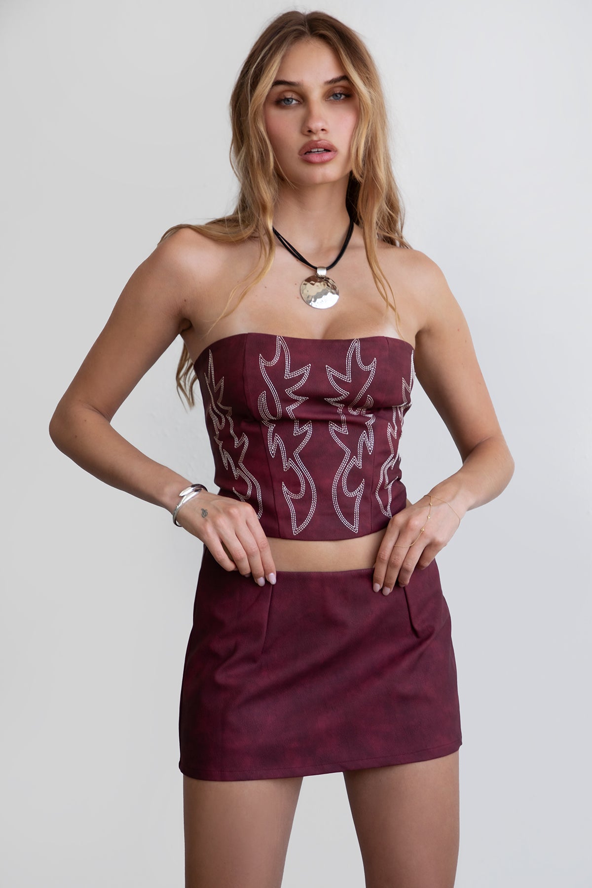 TIC TOC TA29069 BECKEE  PU Vegan Leather Corset Top. Featuring embroidered western details, and an exposed lace up back. Perfect for bold, edgy, and Western-inspired looks.