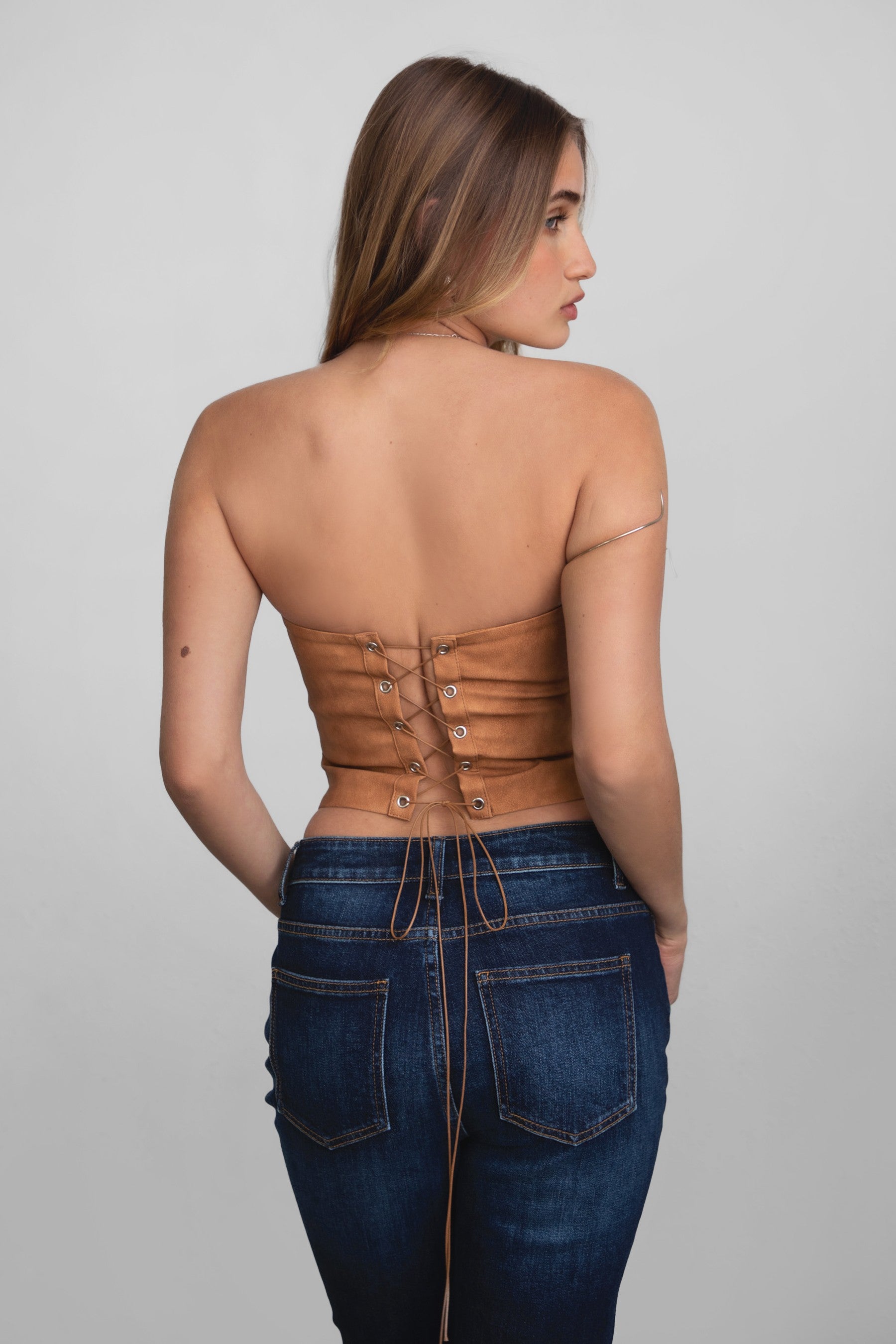 TIC TOC TA29069 BECKEE  PU Vegan Leather Corset Top. Featuring embroidered western details, and an exposed lace up back. Perfect for bold, edgy, and Western-inspired looks.