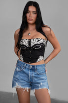 TIC TOC TA30268 MONTANA Embroidered Suede Bustier Top in soft suede with floral embroidery, button-front closure, and asymmetrical hem. Western-inspired festival top