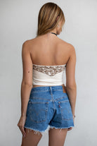 TIC TOC TA30268 MONTANA Embroidered Suede Bustier Top in soft suede with floral embroidery, button-front closure, and asymmetrical hem. Western-inspired festival top