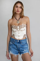 TIC TOC TA30268 MONTANA Embroidered Suede Bustier Top in soft suede with floral embroidery, button-front closure, and asymmetrical hem. Western-inspired festival top