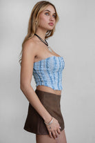 TIC TOC TA30488 FRAYE Distressed Denim Bustier. A strapless cropped corset top with frayed distressed denim edges and a hook-and-eye closure.