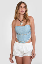 TIC TOC TA30530 GLENDORA Distressed PU Leather Corset Top in blue. Features a sweetheart neckline, boned structure, silver western embellishments, and an adjustable satin lace-up back.