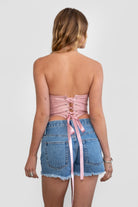 TIC TOC TA30530 GLENDORA Distressed PU Leather Corset Top in blush. Features a sweetheart neckline, boned structure, silver western embellishments, and an adjustable satin lace-up back.