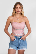 TIC TOC TA30530 GLENDORA Distressed PU Leather Corset Top in blush. Features a sweetheart neckline, boned structure, silver western embellishments, and an adjustable satin lace-up back.