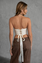 TIC TOC TA30530 GLENDORA Distressed PU Leather Corset Top in cream. Features a sweetheart neckline, boned structure, silver western embellishments, and an adjustable satin lace-up back.