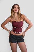 TIC TOC TA30530 GLENDORA Distressed PU Leather Corset Top in red. Features a sweetheart neckline, boned structure, silver western embellishments, and an adjustable satin lace-up back.