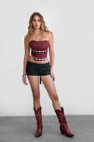 TIC TOC TA30530 GLENDORA Distressed PU Leather Corset Top in red. Features a sweetheart neckline, boned structure, silver western embellishments, and an adjustable satin lace-up back.