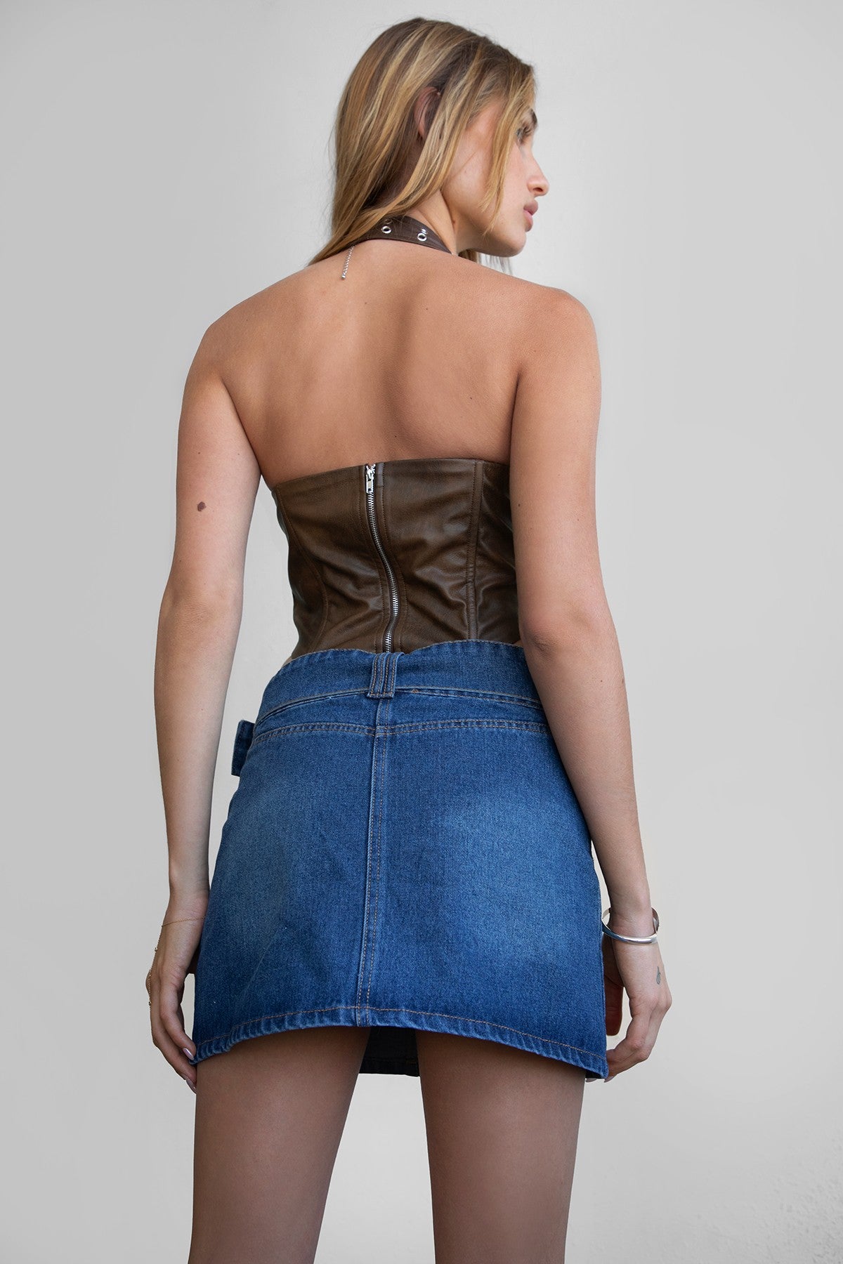 TIC TOC TA30680 DIXY PU Vegan Leather Corset Top. A dark red halter-neck leather top featuring studded details, an exposed back zipper, and a curved hem.