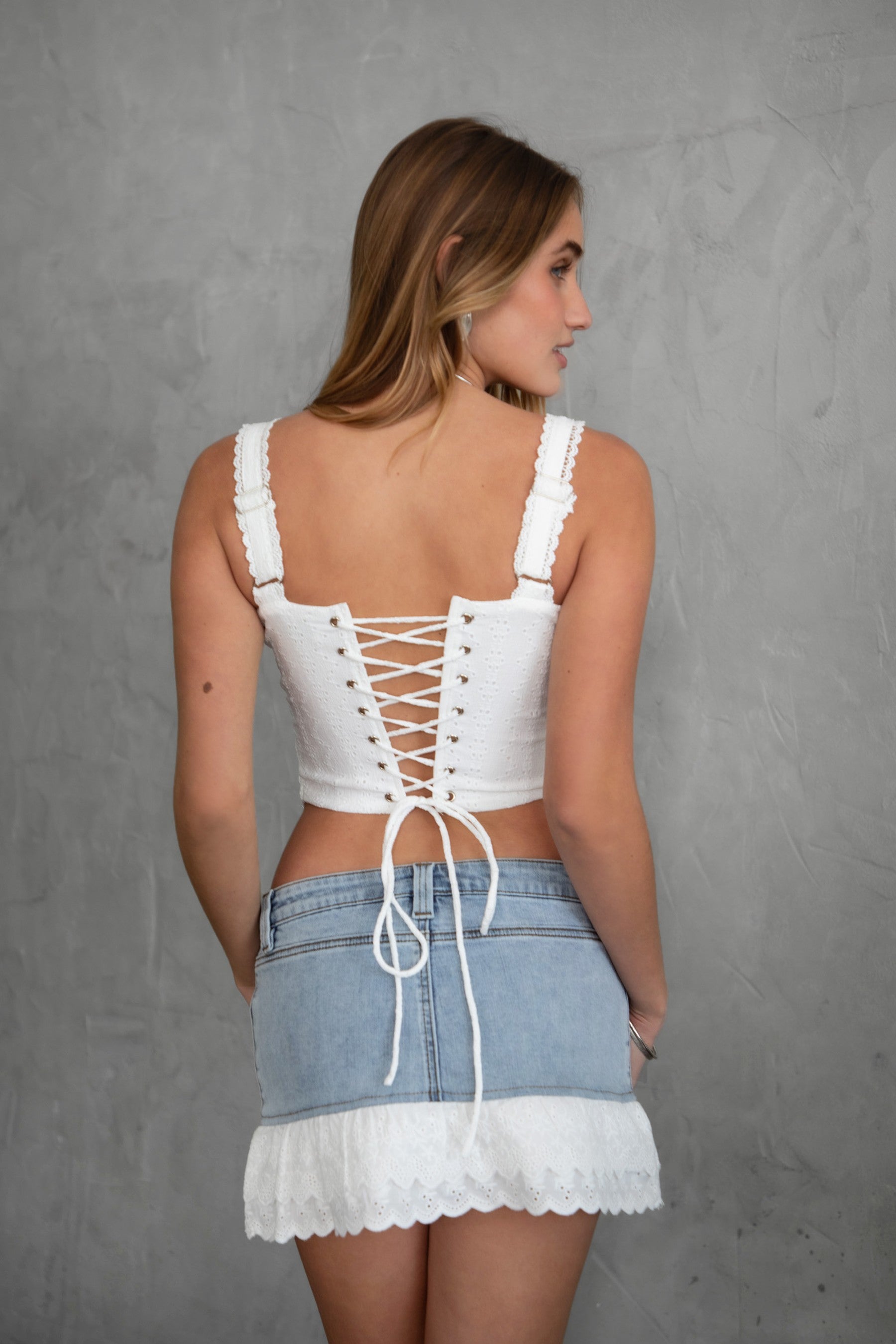 TIC TOC TA30762 DAWSON Eyelet Embroidered Milkmaid Corset Top in white. Features a sweetheart neckline, lace trim, adjustable lace straps, lace-up back, and corset-style bodice.