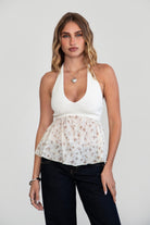 TIC TOC TC30958 GWYNETH Knit Floral Textured Halter Baby Doll Top. Features a V-neckline, self-tie halter straps, empire waist, eyelet embroidery, and a relaxed floaty fit.