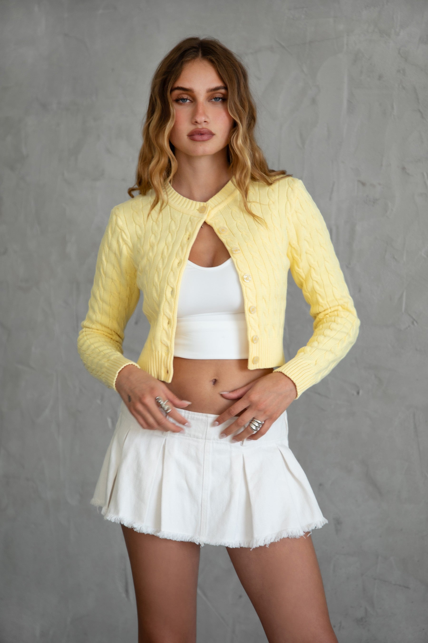 TIC TOC TC31026 NOAH Cable Knit Cardigan Top in soft stretch knit fabric. Features a crew neckline, front button closure, ribbed cuffs, and waist.