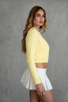 TIC TOC TC31026 NOAH Cable Knit Cardigan Top in soft stretch knit fabric. Features a crew neckline, front button closure, ribbed cuffs, and waist.