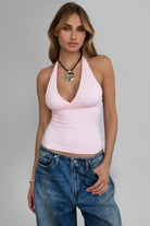 Pink halter cami top by Tic Toc featuring a low V neckline and open back.