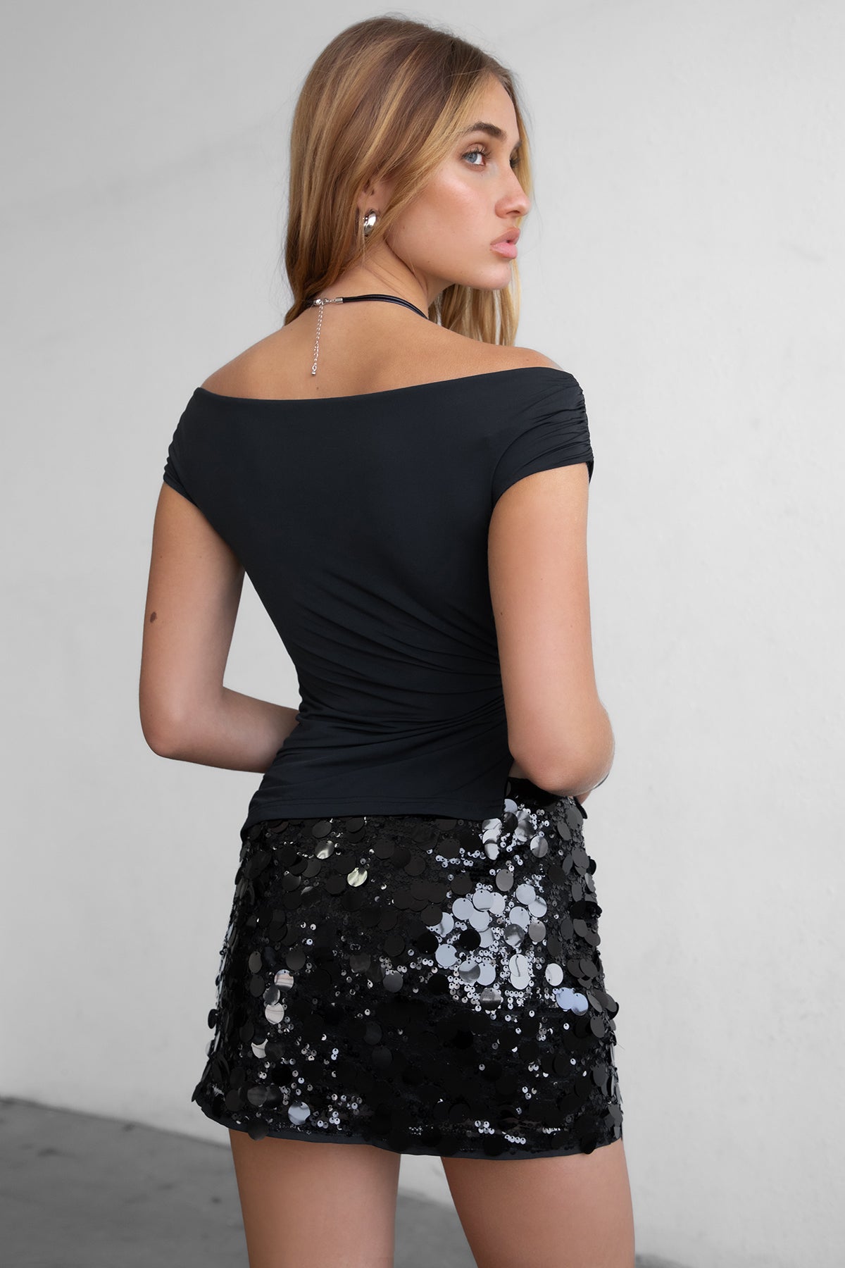 Black off the shoulder short sleeve top with asymmetric hem and silver ring detail by Tic Toc.