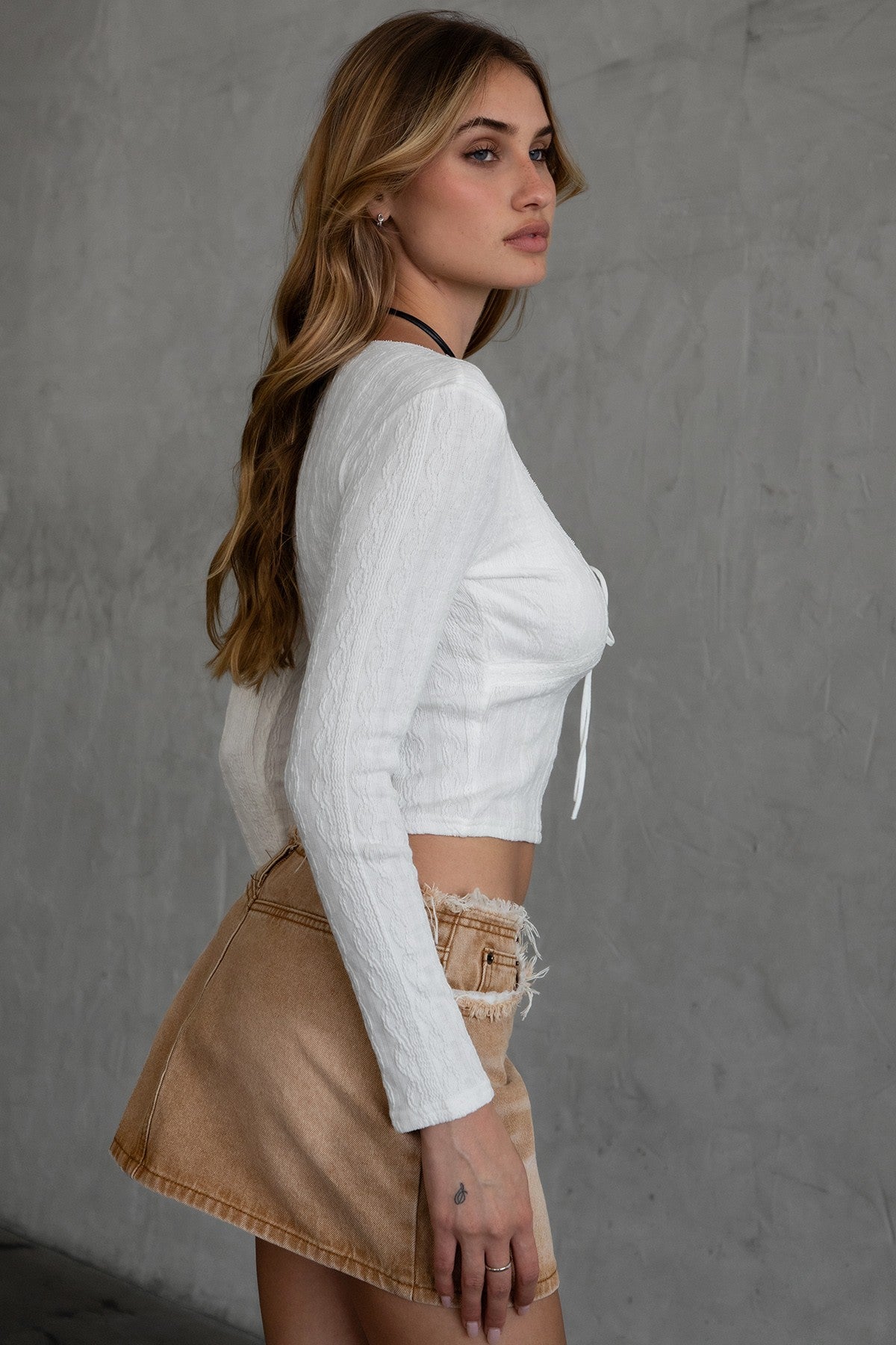 TIC TOC TH30539 DINAH Jacquard Long Sleeve Top in white. Features a low scoop neckline, self-tie at the bust, fitted silhouette, and textured stretch fabric.