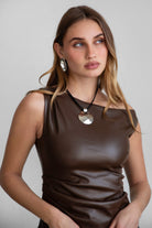 TIC TOC TH30973 SHOCO PU Vegan Leather Top in sleek vegan leather. Features a single off-the-shoulder design, ruched bodice, and hidden zipper closure.