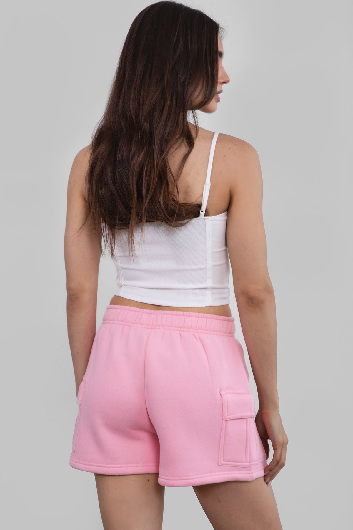 Pink mid-rise fleece shorts featuring an elastic waistband and cargo-style pockets by Tic Toc.