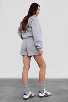 Heather grey mid-thigh fleece shorts with functional cargo pockets and a soft texture from Tic Toc.