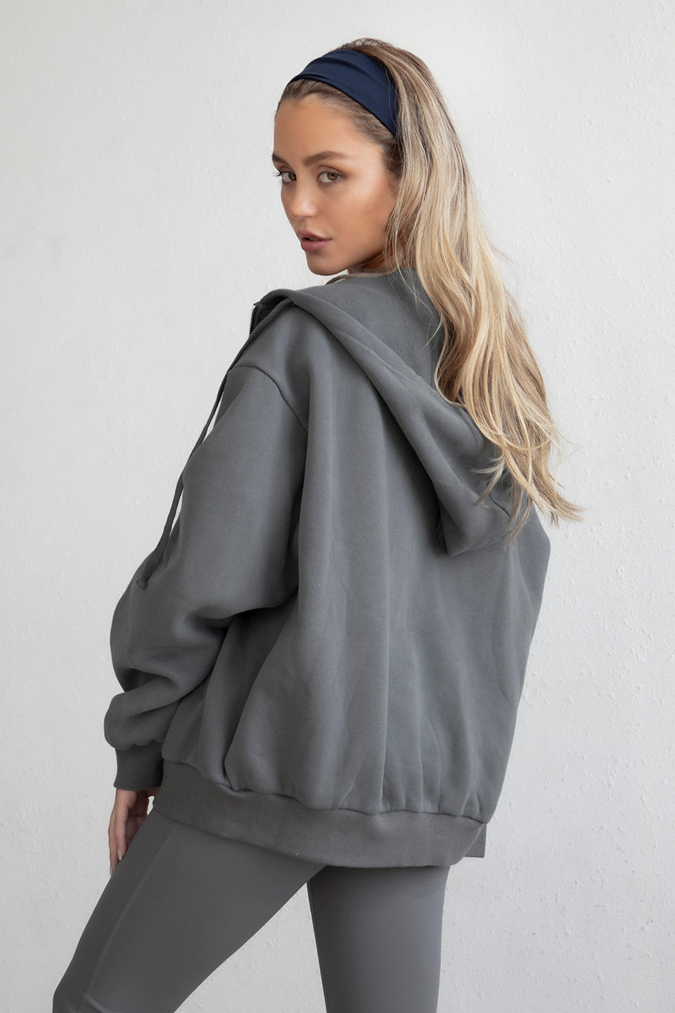 Graphite grey oversized hoodie featuring a full zipper and side welt pockets for storage by Tic Toc.