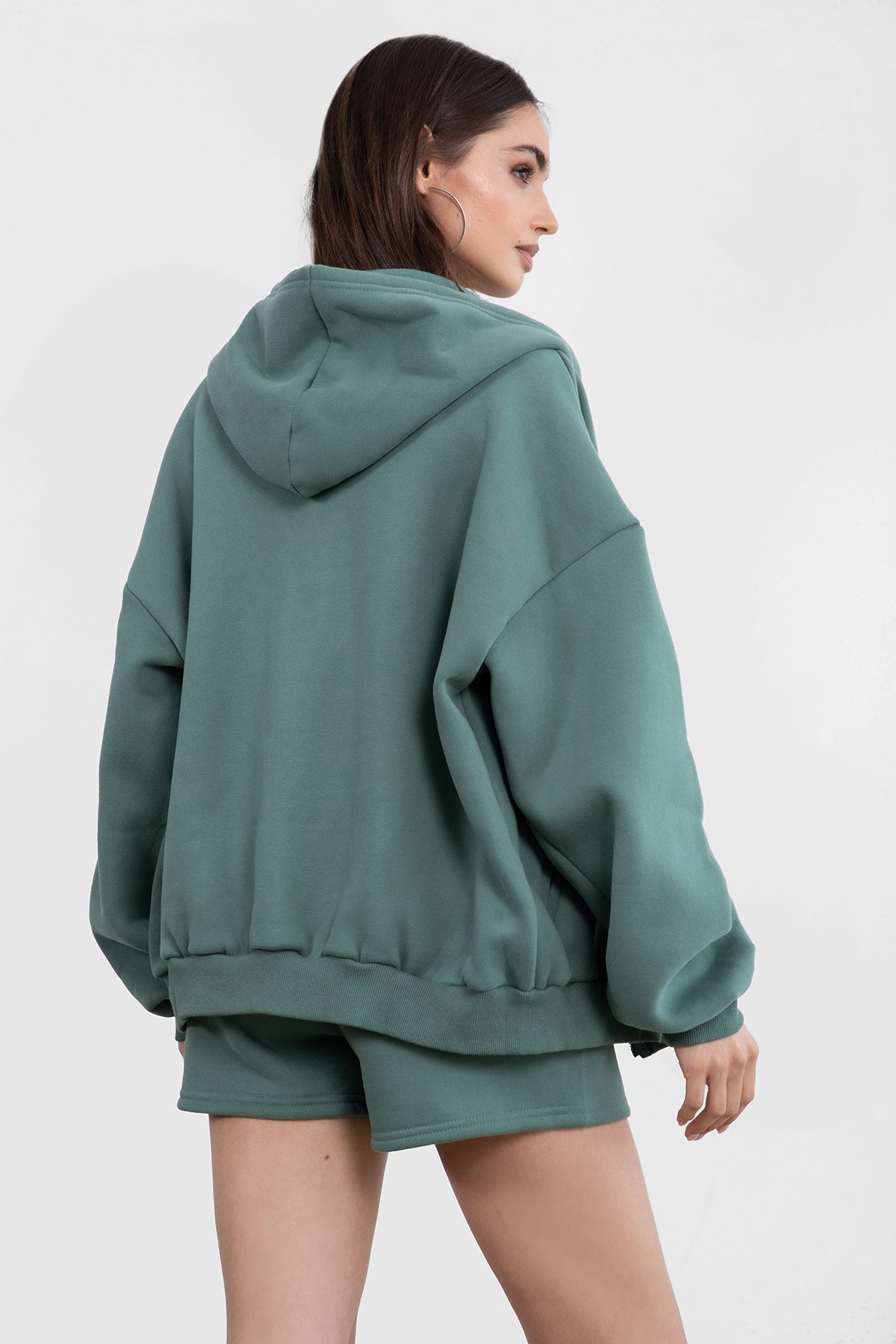 Pine green oversized hoodie with side welt pockets and an adjustable drawstring hood for a cozy feel by Tic Toc.