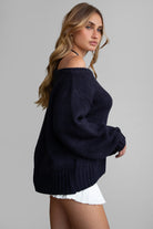 BRANDY off-the-shoulder ribbed knit sweater in black with long loose sleeves