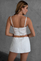 White floral lace bustier top with asymmetrical hem and nude contrast lining by TIC TOC