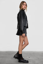 Chic black PU leather shacket with functional buttons and collared neckline