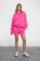 Relaxed fit fleece sweater for women with dropped shoulders and plush cozy fabric in fuchsia