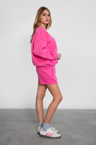 Relaxed fit fleece sweater for women with dropped shoulders and plush cozy fabric in fuchsia