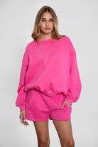 Relaxed fit fleece sweater for women with dropped shoulders and plush cozy fabric in fuchsia