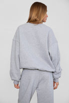 Relaxed fit fleece sweater for women with dropped shoulders and plush cozy fabric in heather  grey