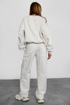 Relaxed fit fleece sweater for women with dropped shoulders and plush cozy fabric in heather white