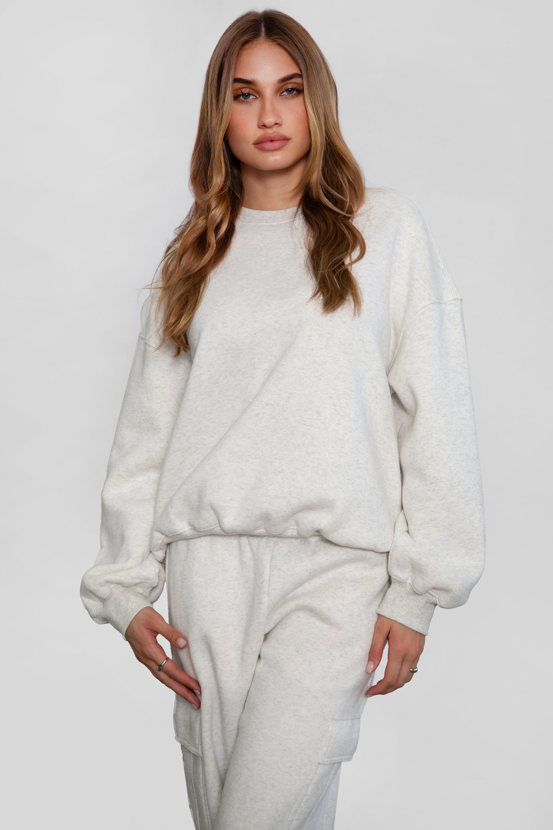 Relaxed fit fleece sweater for women with dropped shoulders and plush cozy fabric in heather white