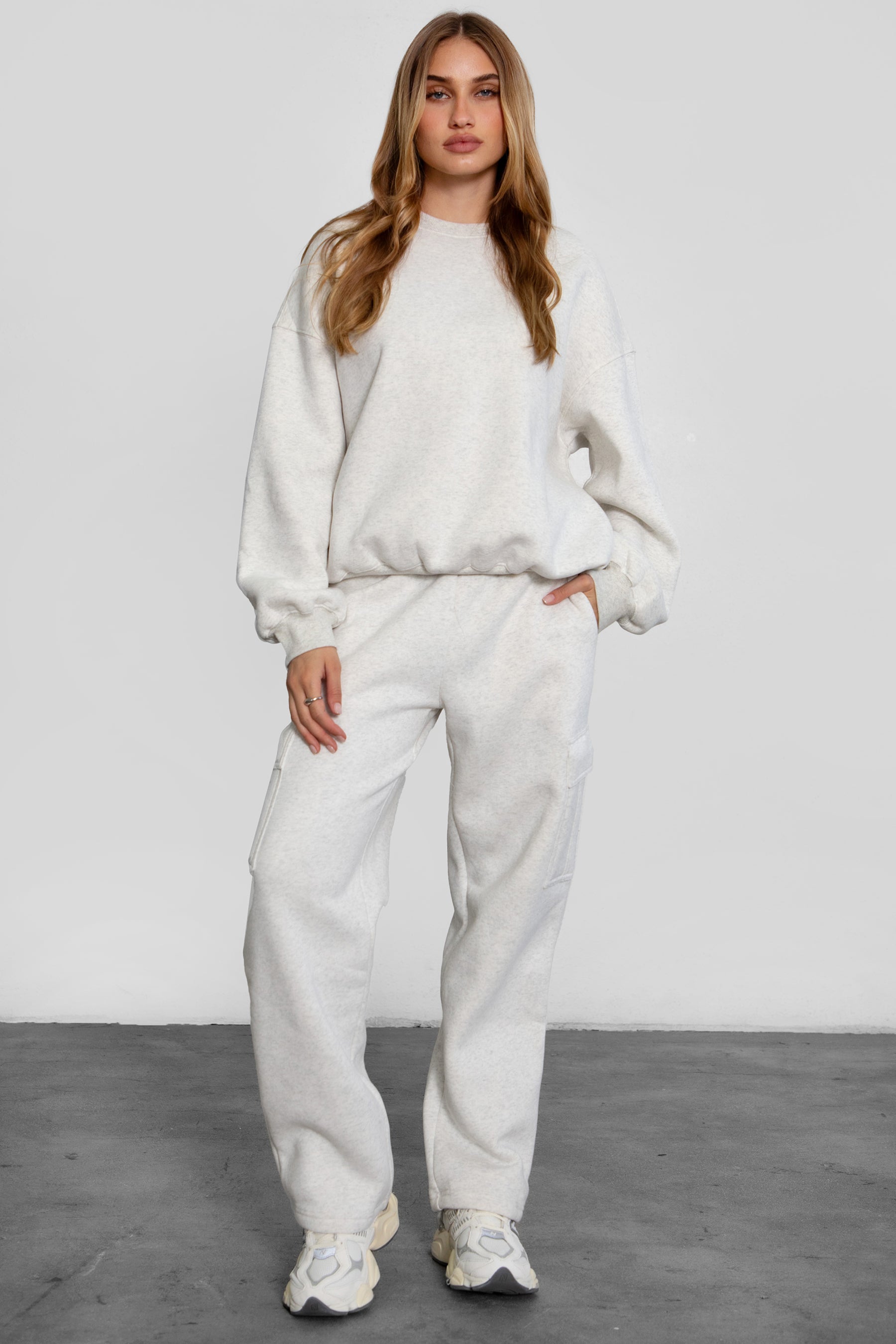 Relaxed fit fleece sweater for women with dropped shoulders and plush cozy fabric in heather white